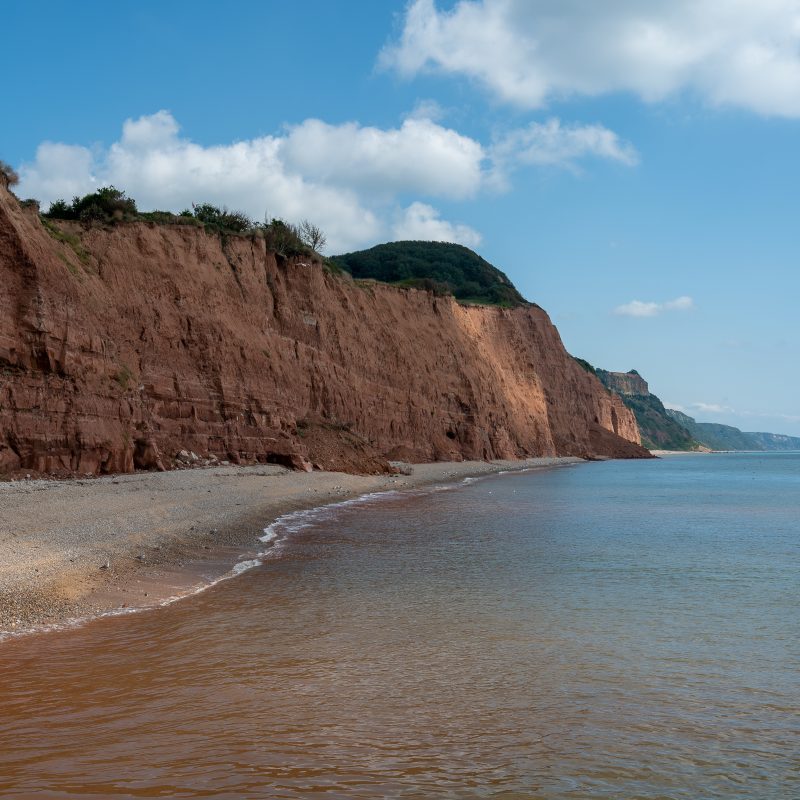 Photo of coastline, red rock