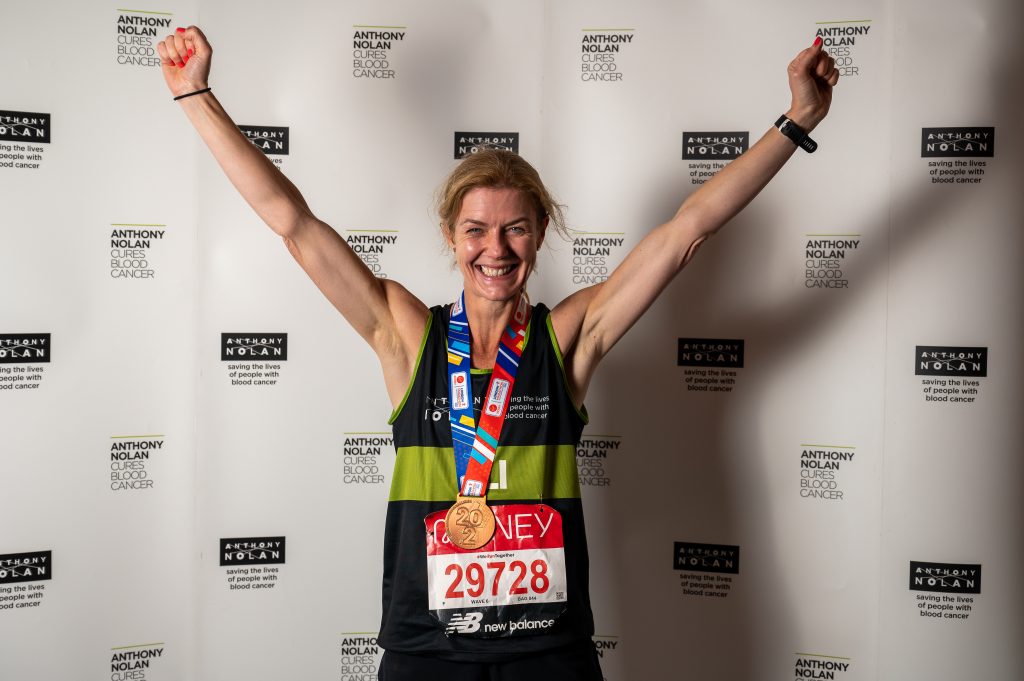 Lady wearing running vest with arms held up high